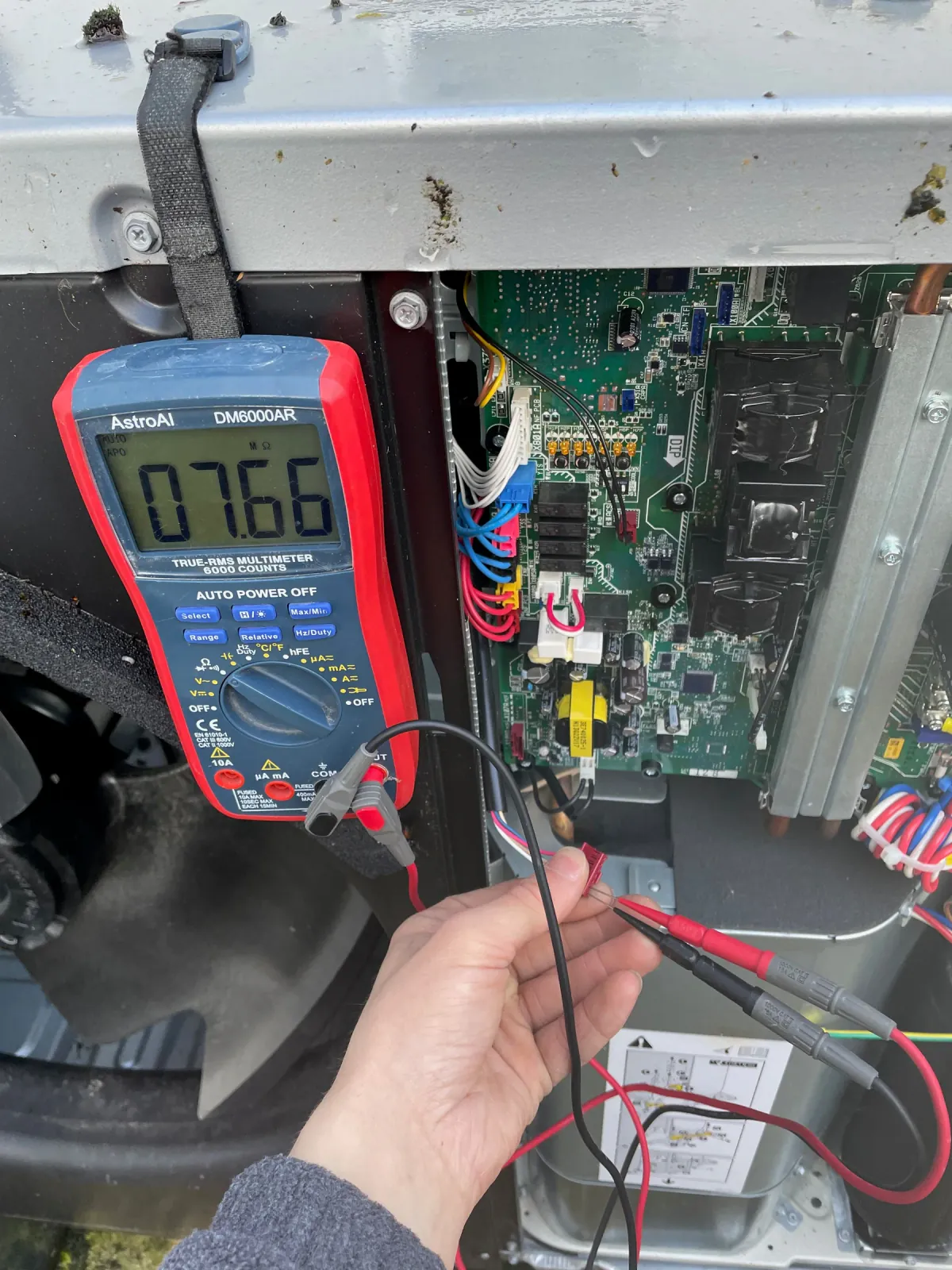Electrical diagnosis being carried out inside an air source heat pump