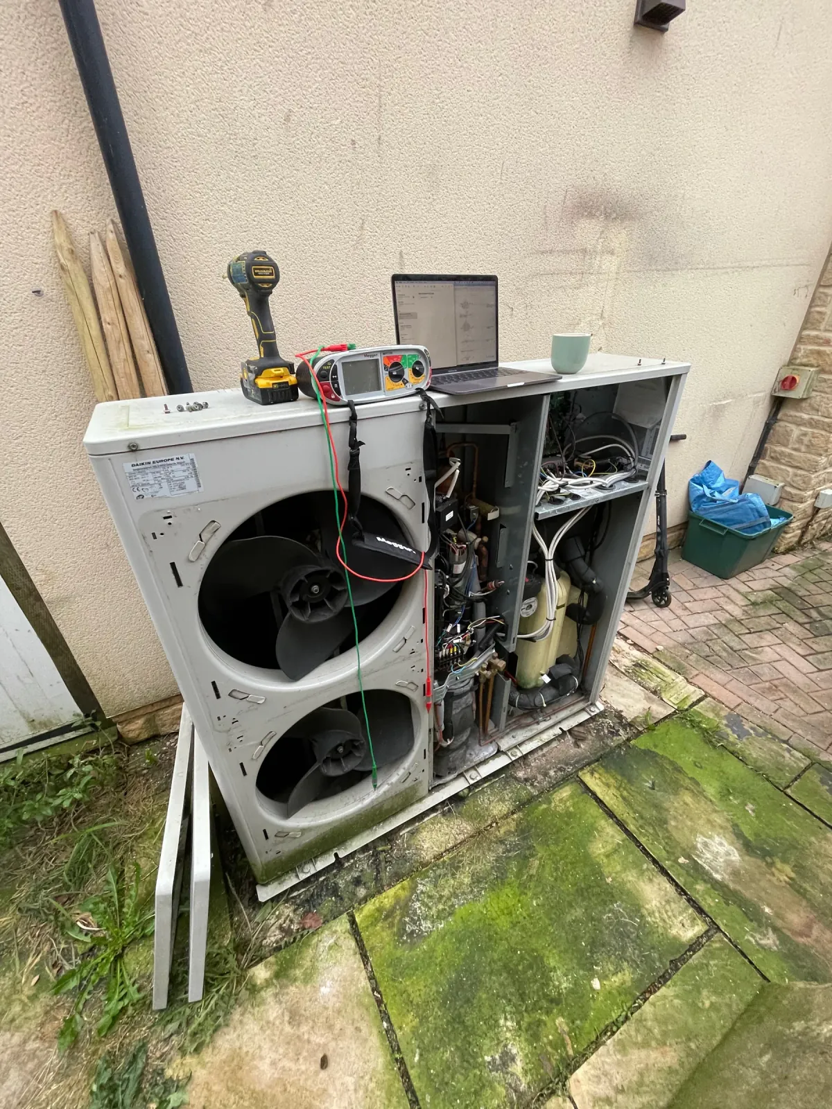 Diagnostic equipment and laptop used during a methodical heat pump investigation